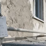 Crepie : crépi sur façade en béton, truelle et échafaudage